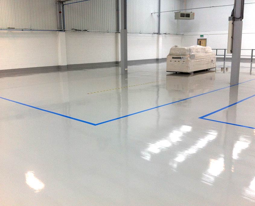 Light grey warehouse flooring system with blue line markings