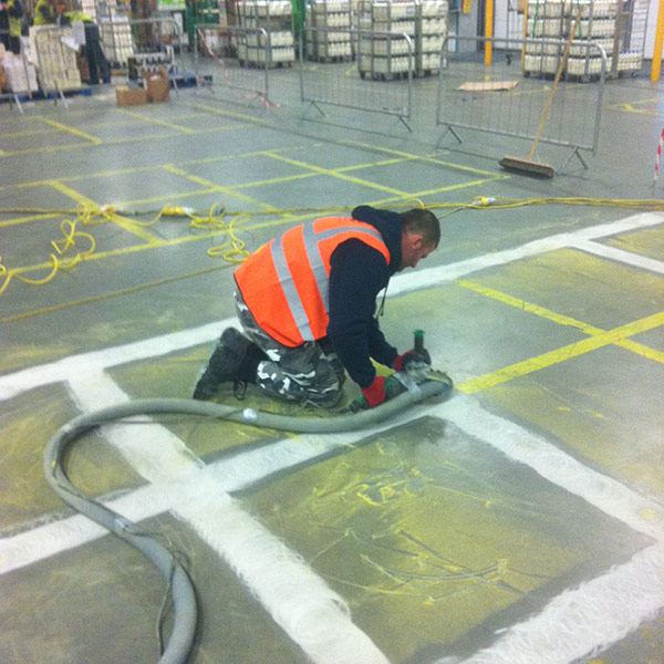 Man making lines on the floor with a machine