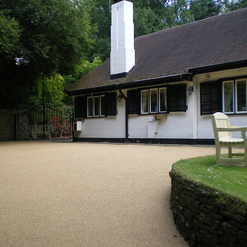 Image of a white bungalow with a resin bound driveway.