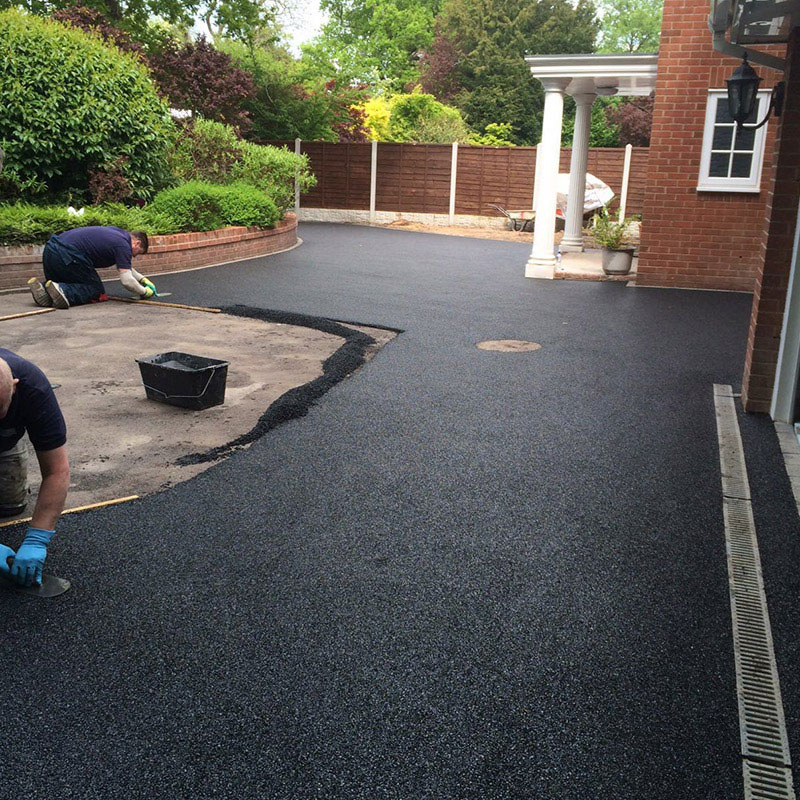 Men laying down and flattening a Resin bound driveway