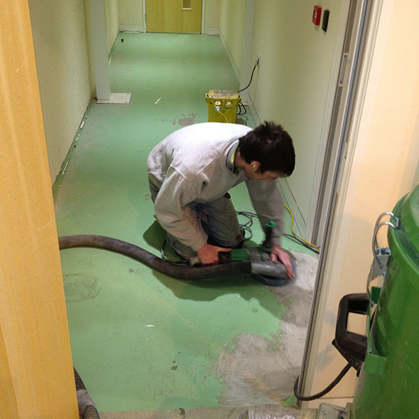 man using machine to scrub the floor