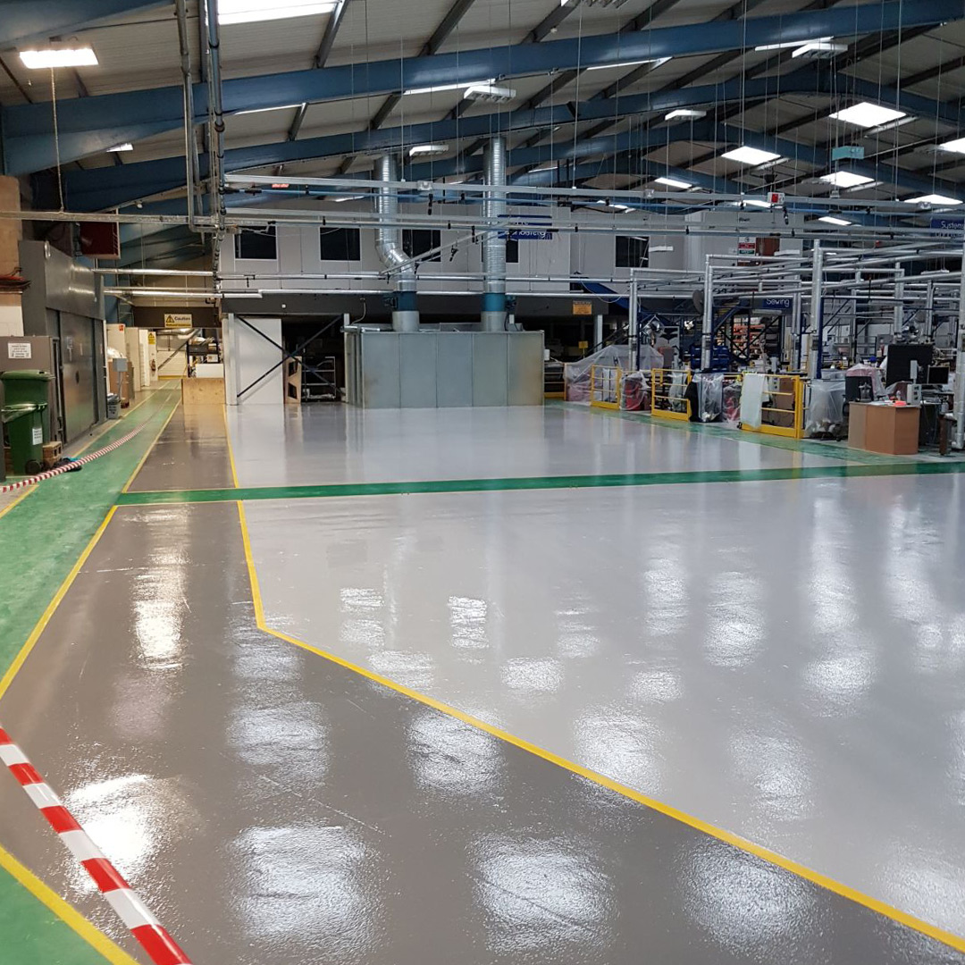 Pale grey, mid grey, yellow and green floor markings for automotive flooring