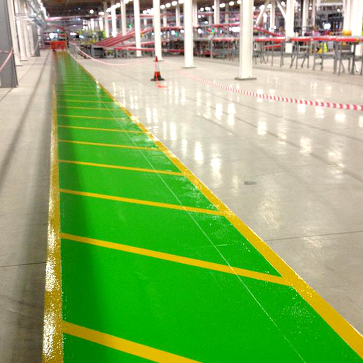 Green and yellow floor markings in a warehouse