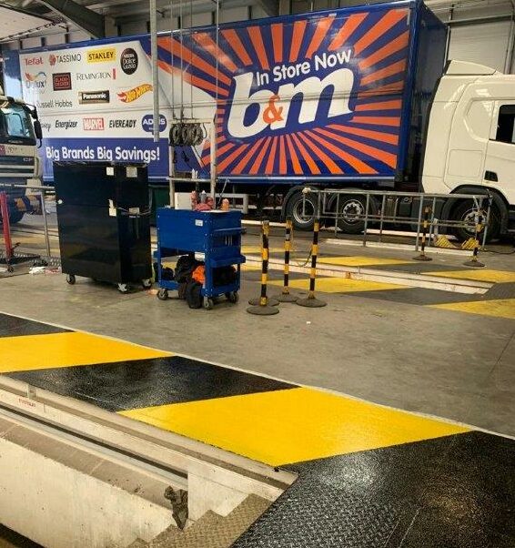 Yellow and black line markings in a B&M warehouse