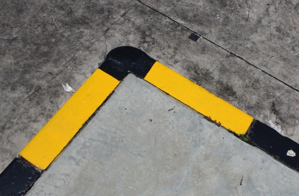 Yellow and black masking over grey concrete