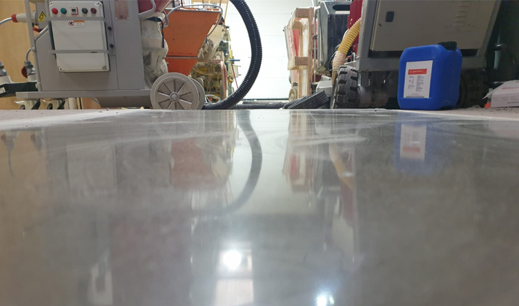 Reflections in a shining white polished screed floor