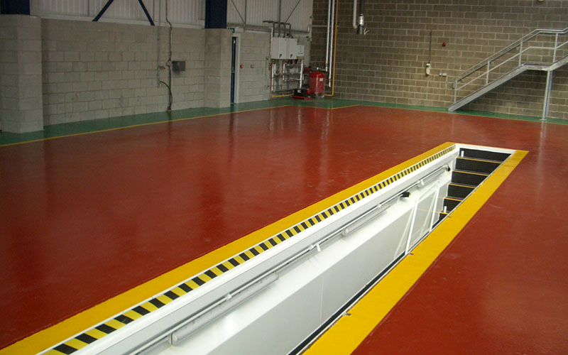 red epoxy resin floor coating with line demarcation to warn of a staircase