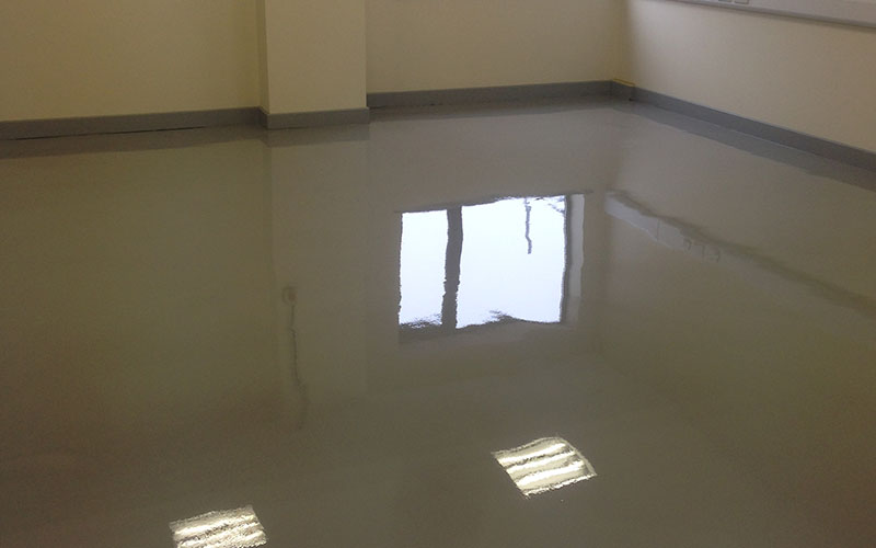 resin flooring reflecting the light coming through a window