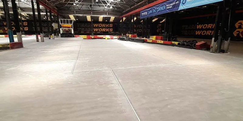 Pumped screed flooring in a warehouse with a racecourse.