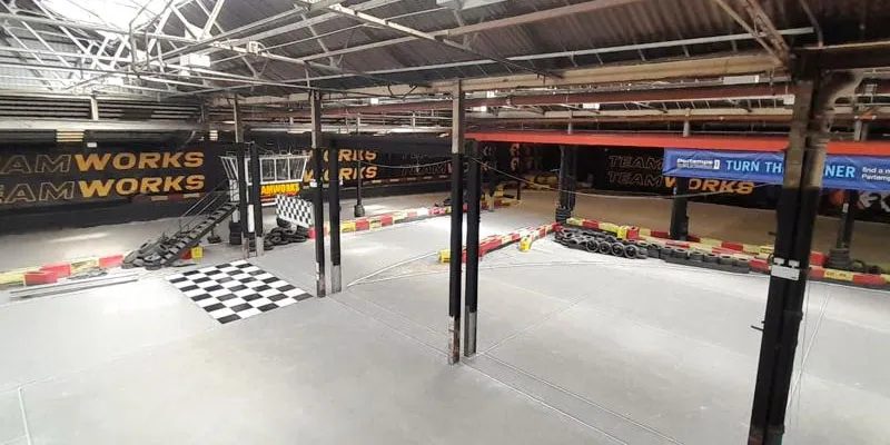 Rapid pumped screed laid on a racecourse warehouse building.
